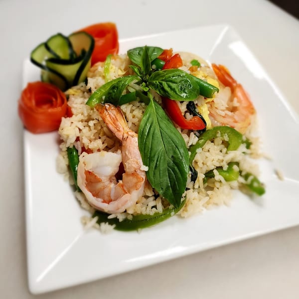 Thai House Bistro's shrimp fried rice with basil, bell peppers, and decorative vegetable garnishes.